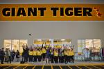 Giant Tiger Saint John, N.B., employees outside the exterior of the store with their hands in the air, celebrating the official opening. 