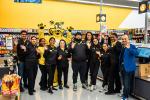 Giant Tiger staff members pose in store with Friendly, the Giant Tiger. 