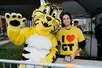 Friendly, the Giant Tiger poses for a photo with a Giant Tiger employee. 