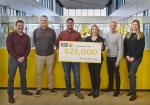 Danielle Lalonde, Director of Communications – Internal at Food Banks Canada, and Josh McJannett from Dominion City Brewing Co., join Giant Tiger’s grocery team at Home Office to accept a $25,000 donation from funds raised in support of Food Banks Canada.