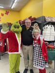 Giant Tiger Dartmouth employee, Scott poses with the Grinch and Cindy-Lou Who. 