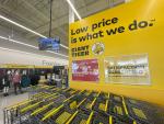 Giant Tiger Camrose, Alta., featuring a yellow wall that displays the words “Low price is what we do. Giant Tiger,” above rows of shopping carts, along with signs that say “giant value. Lowest prices on our shelves!” and “Satisfaction Guaranteed...