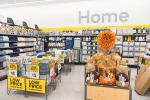 Giant Tiger Camrose, Alta., featuring bins of home décor items such as towels and blankets, with festive fall items. The word “Home” is displayed on the wall above the shelves of bathroom items.