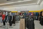 Giant Tiger Saint John, N.B., women’s fashion assortment, including dresses and pants with the word “Fashion” displayed on the back wall.