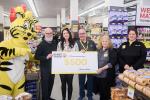 Friendly, the Giant Tiger, Ottawa Councillor Jeff Leiper, Ottawa Humane Society staff member, hold a $500 presentation cheque with three Giant Tige Hintonburg employees. 