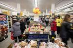 Giant Tiger Hintonburg featuring customers shopping around the fruit and pastries displays. 